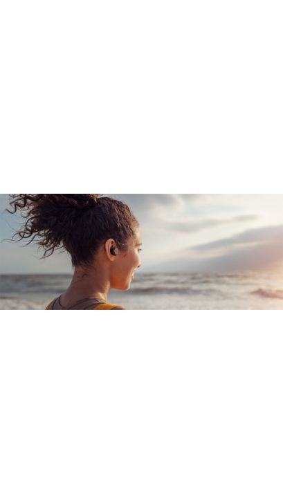 Woman wearing wireless Philips headphones
